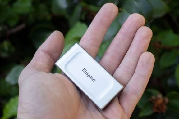 Kingston XS2000 — Tiny silver external SSD with black rubber sleeve