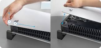 PS5 Plate Removal — hands sliding the white PS5 cover down to reveal the fan and SSD bay